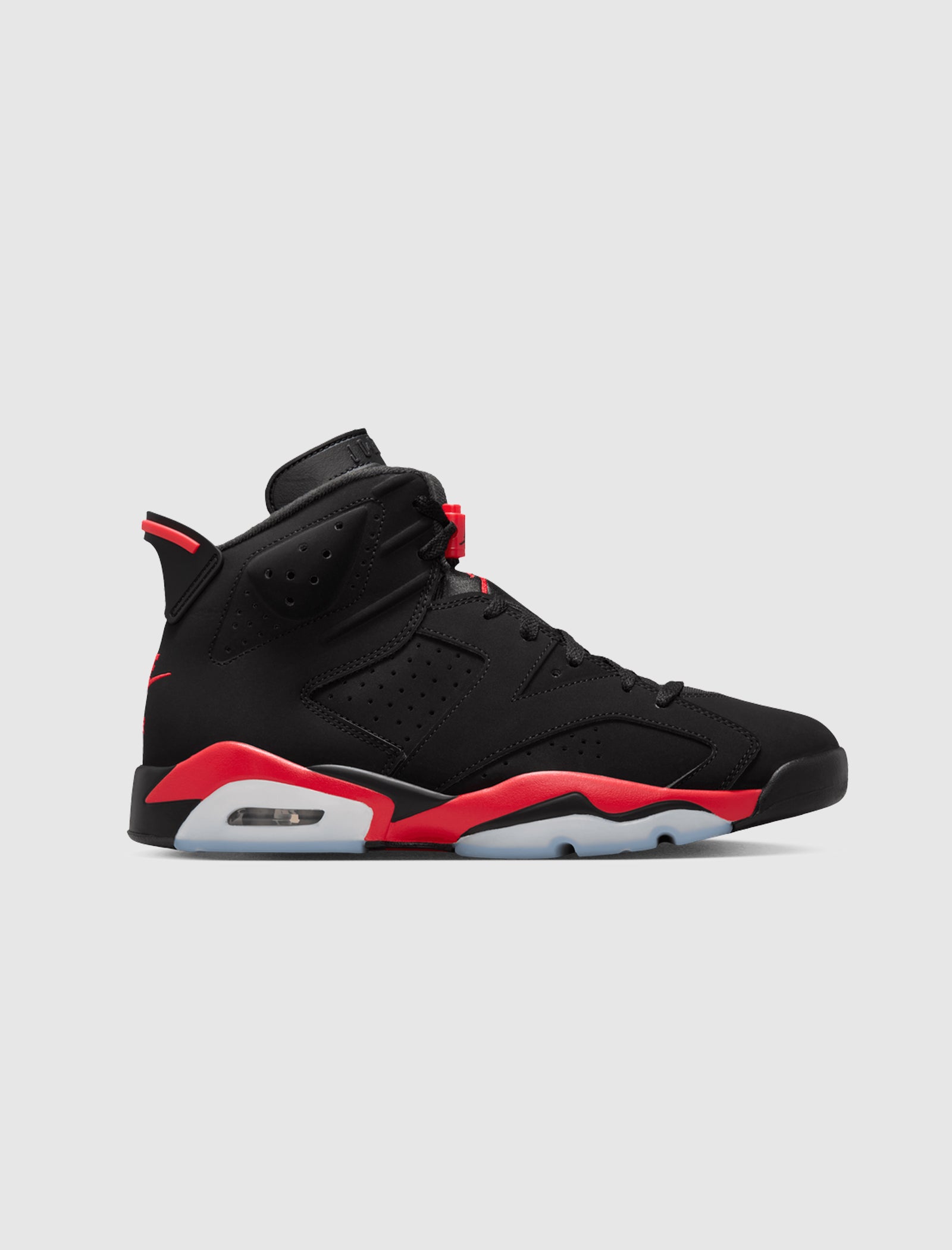 The AIR JORDAN 6 RETRO "INFRARED SALESMAN" is a black high-top sneaker made from nubuck leather with red accents, featuring a visible heel air cushion, foam midsole, and a translucent rubber sole on a plain light gray background.