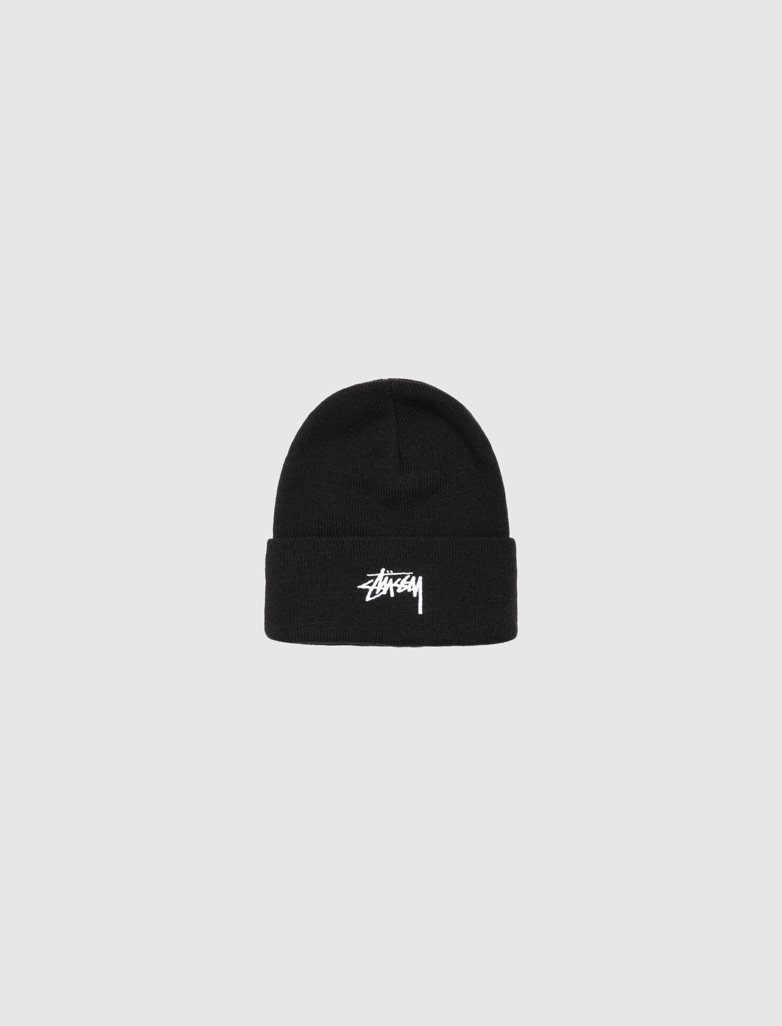 A black Stüssy STOCK CUFF BEANIE with a folded brim and embroidered front logo, shown on a plain light gray background.