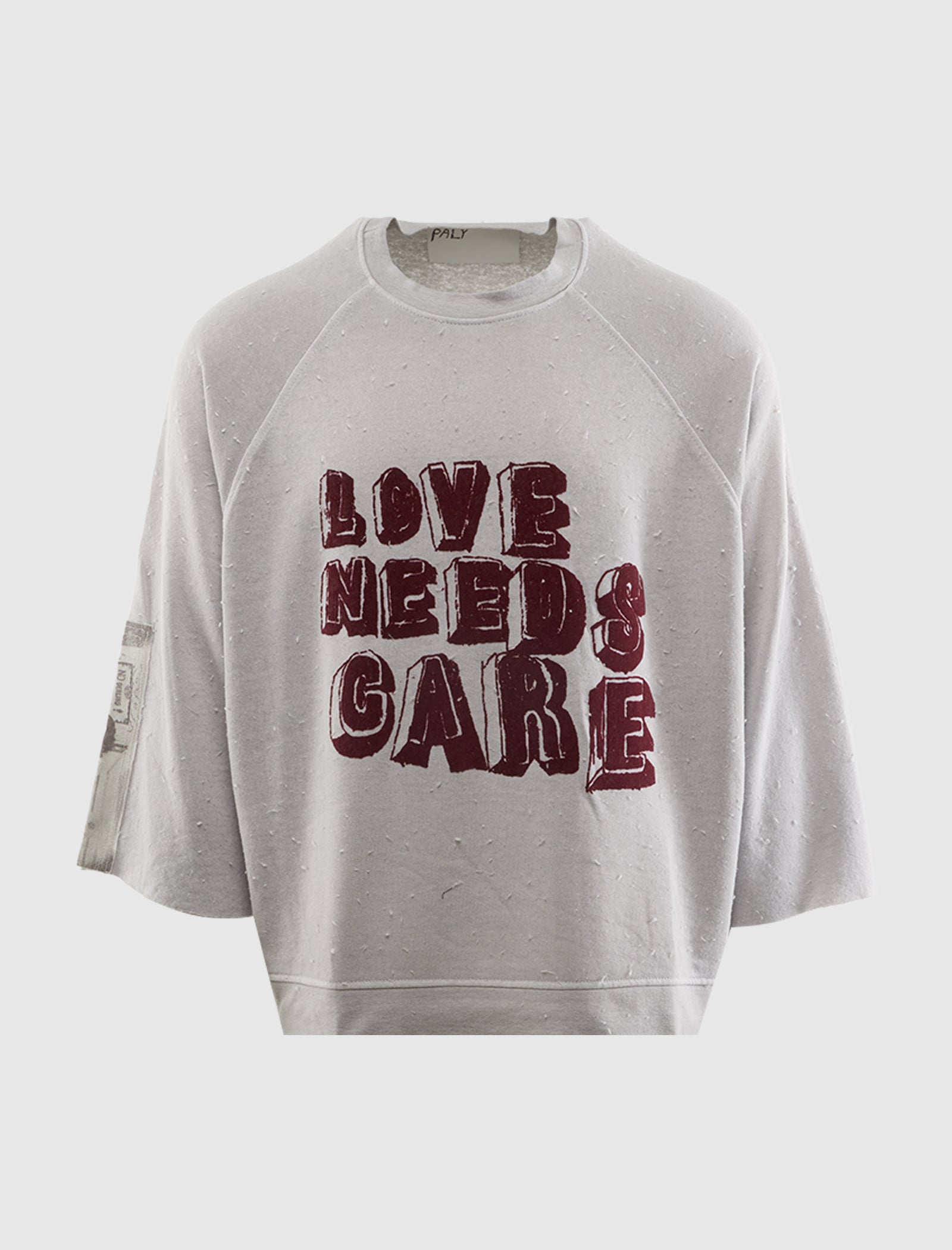 LOVE NEEDS CARE CREWNECK