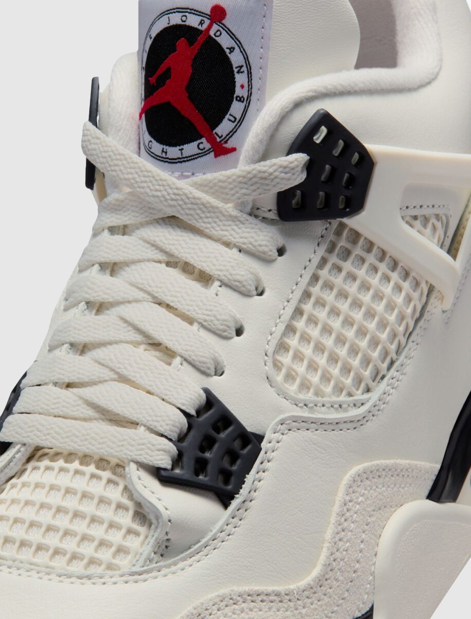Close-up of the AIR JORDAN 4 RETRO OG "FLIGHT CLUB" mid-top sneaker, featuring white laces, mesh panel, black lace holders, suede overlay, and a tongue tag with the red Jumpman logo and "Flight" text.