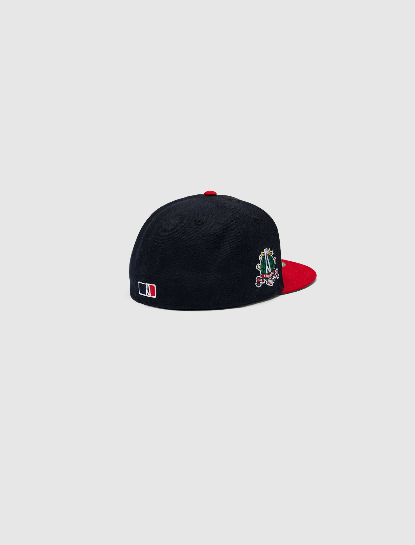 The A MA MANIÉRE 5950 A LOGO HAT by New Era is a navy baseball cap with a red brim, small side embroidery, and an MLB logo on the back, shown against a plain light gray background.