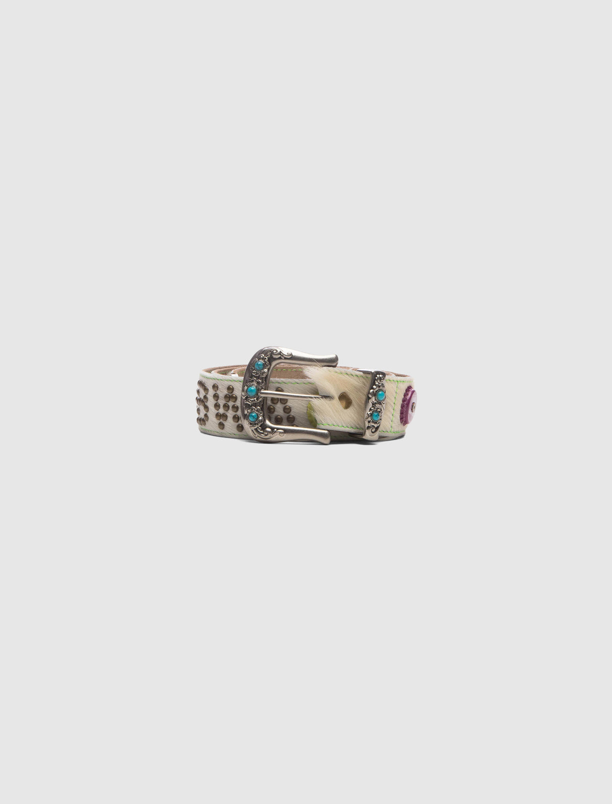 CHASTITY BELT featuring a silver buckle with turquoise insets, a textured white strap with metal studs, and decorative floral accents.