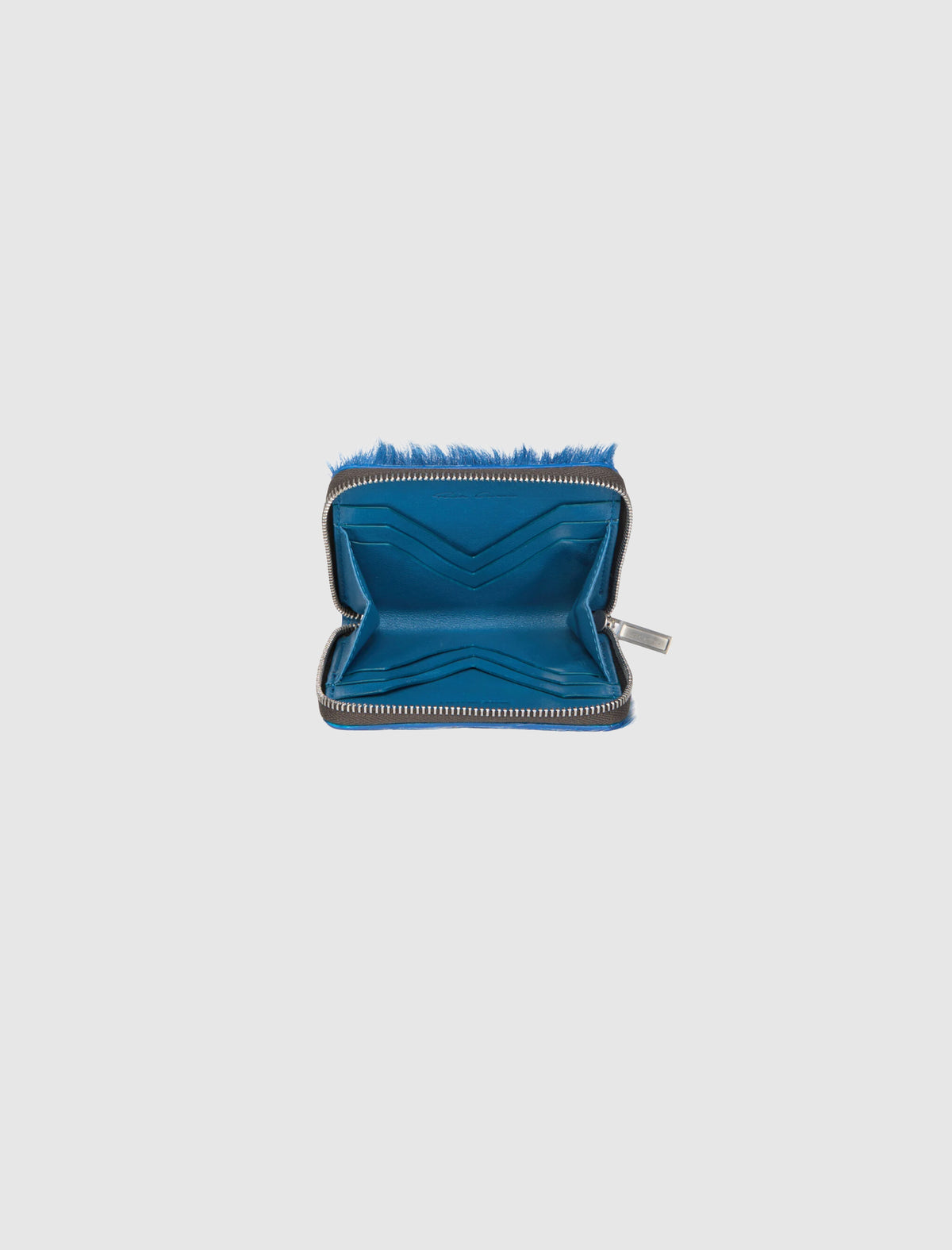 Open blue ZIPPED WALLET with a zip closure, multiple card slots, and a textured hair-on leather exterior.